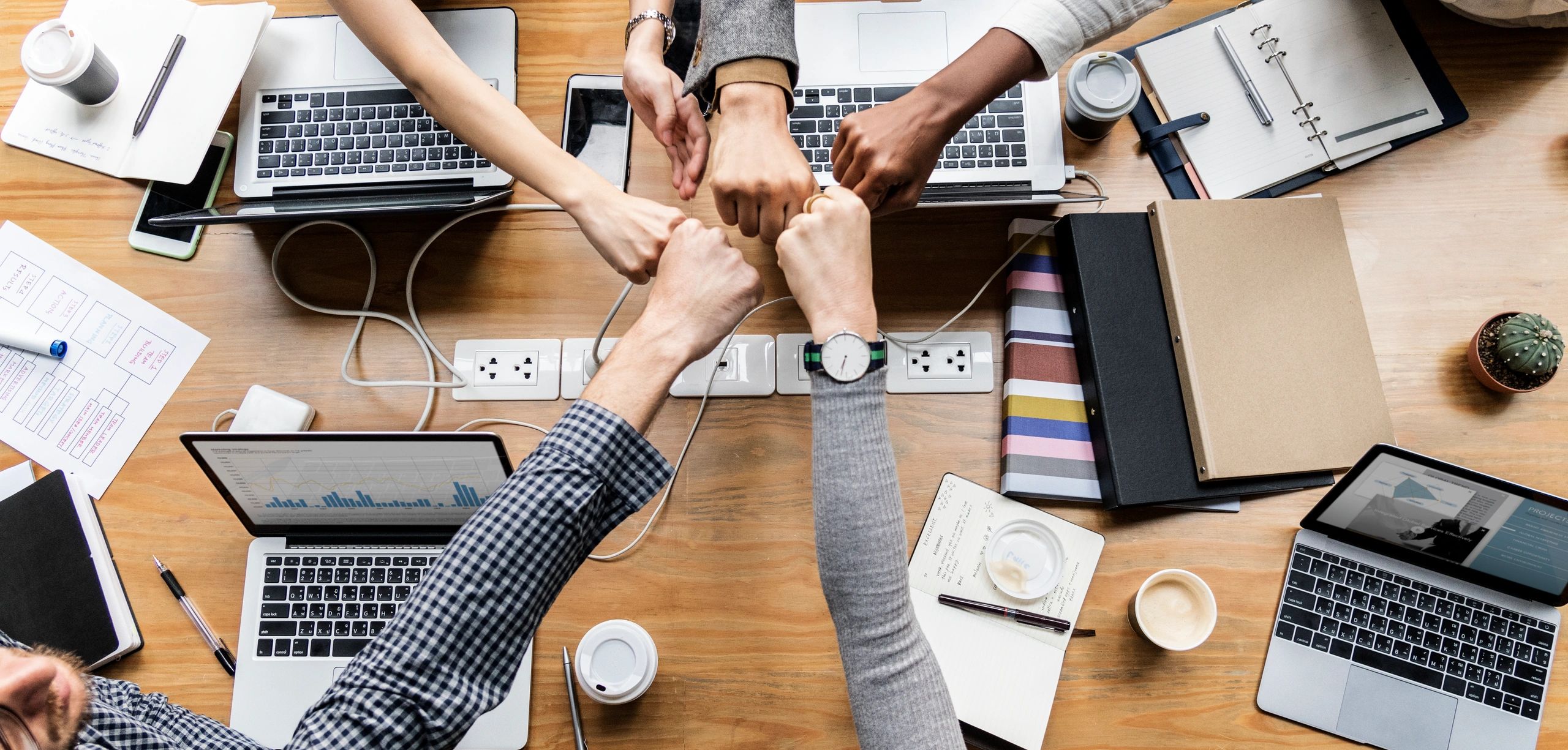 Colleagues bringing their hands together in a fist bump